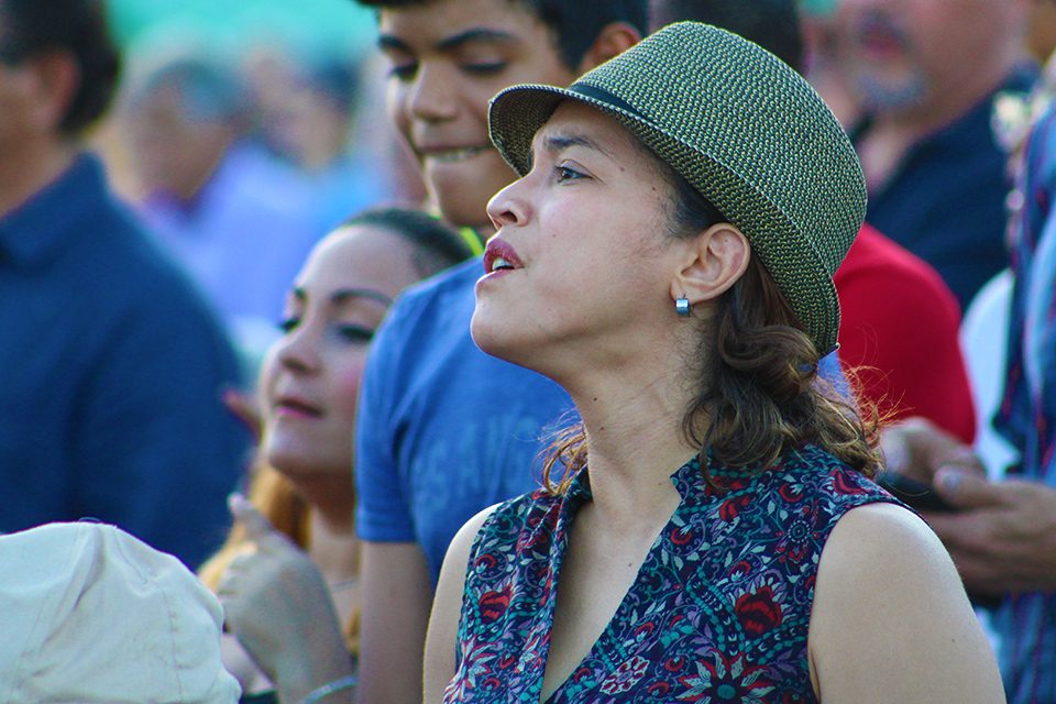 Woman in hat. singing