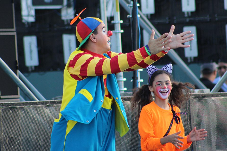 Man in clown suit, clapping