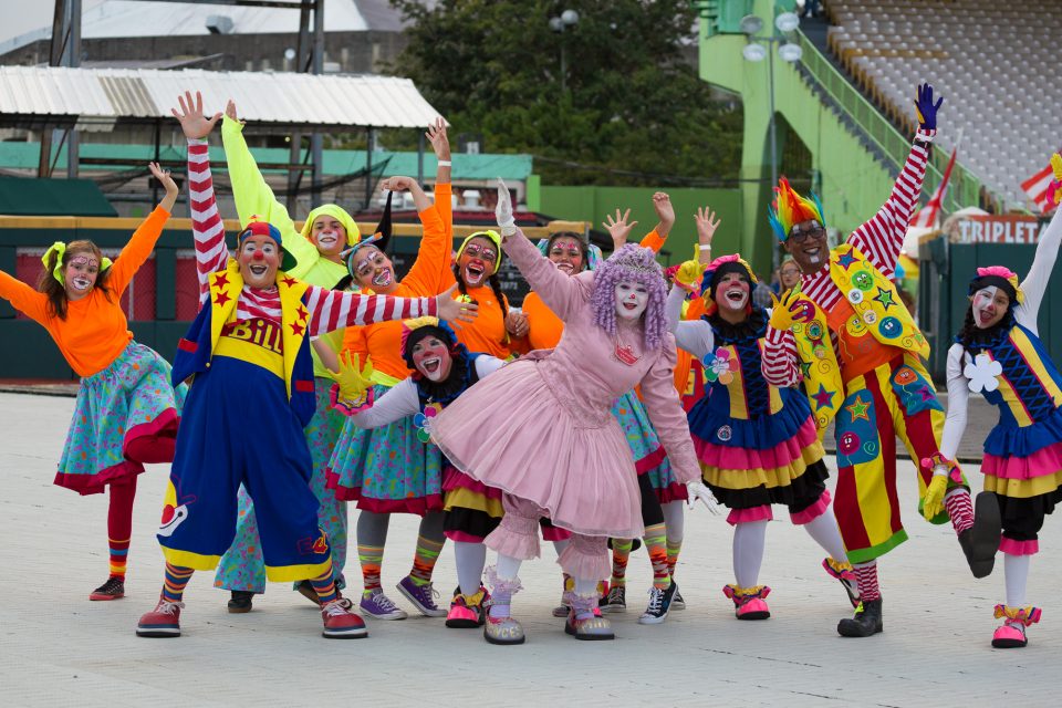People dressed in colorful clown costumes