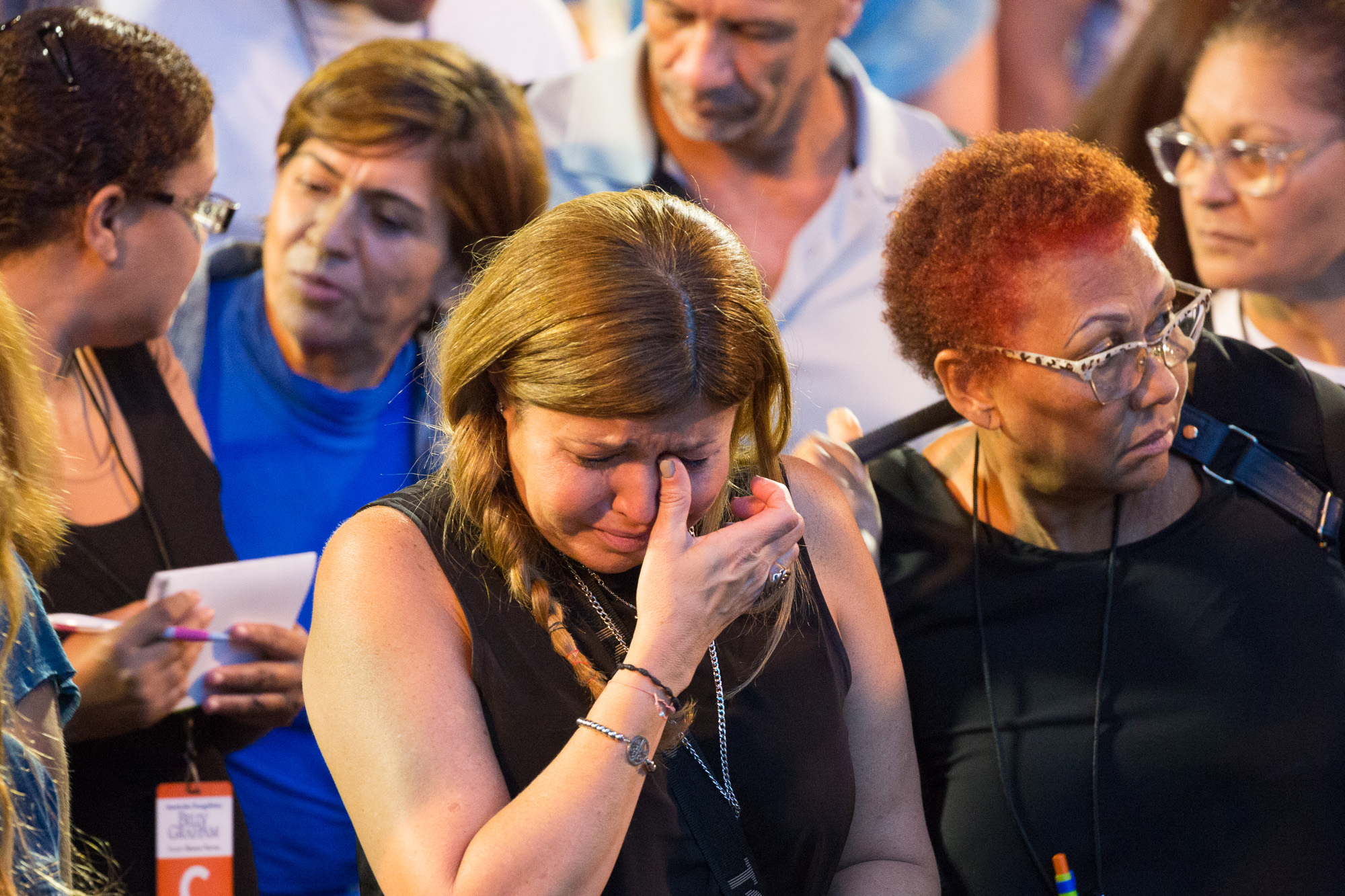Woman wipes away tear at Festival