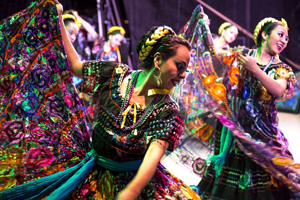 Dancers in brightly colored dresses