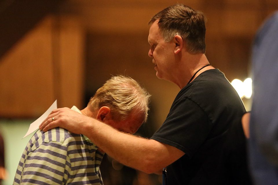 Man praying with another man who received Christ