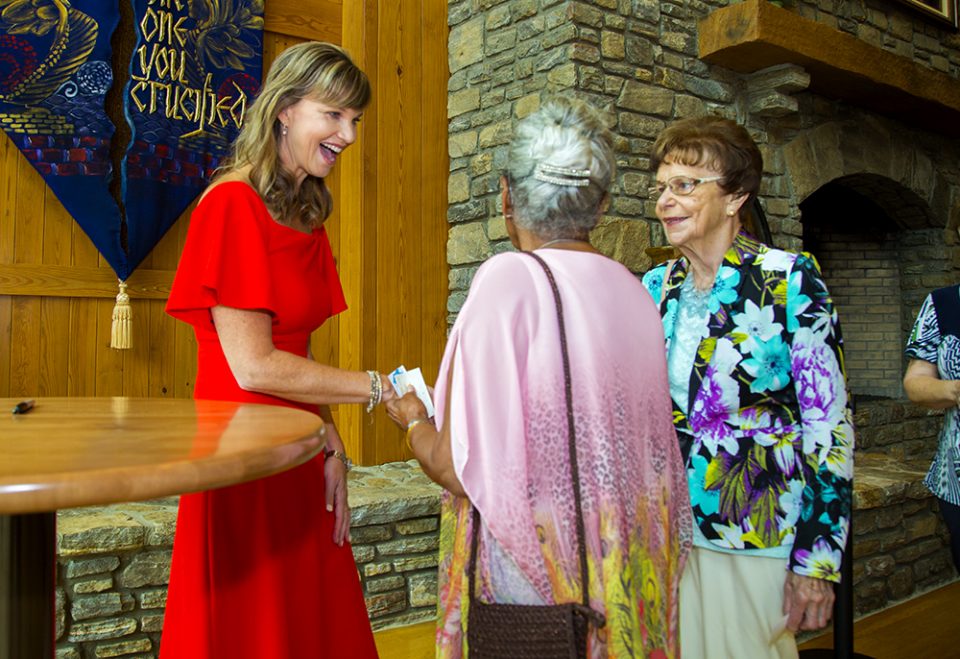 Missy Robertson greeting two guests