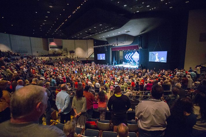 Large crowd of people facing stage