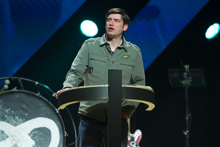 Will Graham preaching behind podium