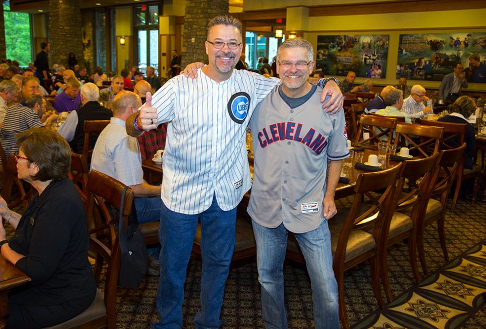 Men wearing Chicago Cubs and Cleveland Indians jerseys