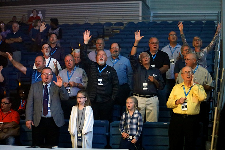 People worshiping God with hands raised