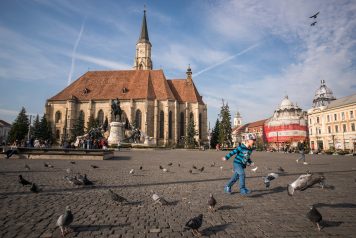 Saint Michael's Church in Cluj-Napoca; child chasing birds