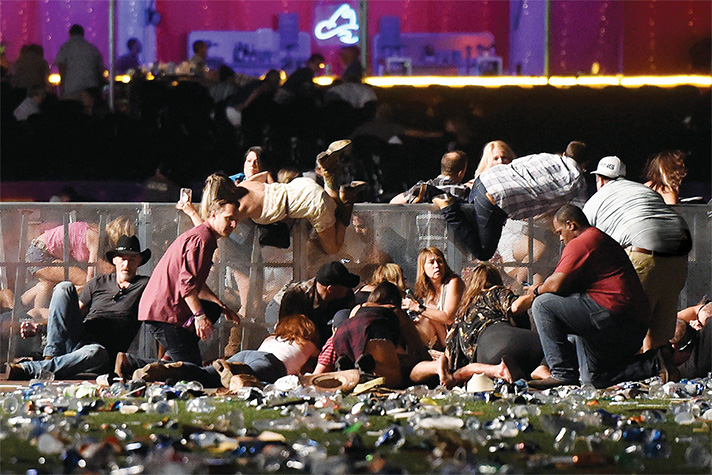People rolling over fence; others hiding behind fence