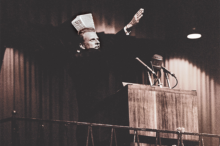Billy Graham preaching, holding Bible