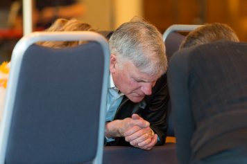 Franklin Graham kneeling and praying