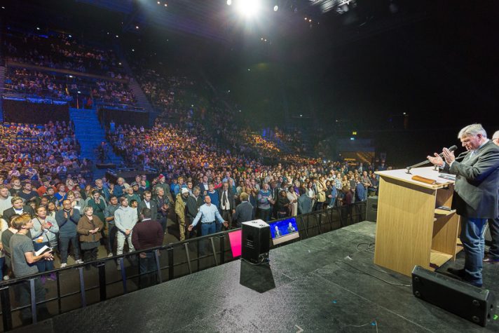 Franklin Graham onstage as people fill space in front of stage.