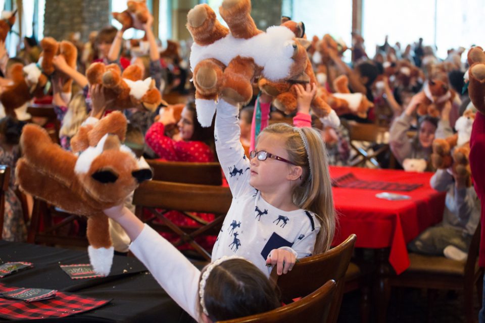 Children held up their new plush foxes