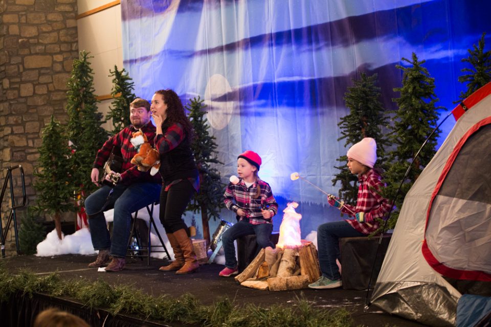 The Christmas story is told and children are led in campfire songs