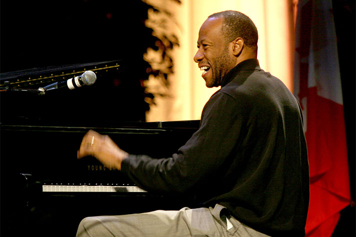 Huntley Brown smiling and playing piano