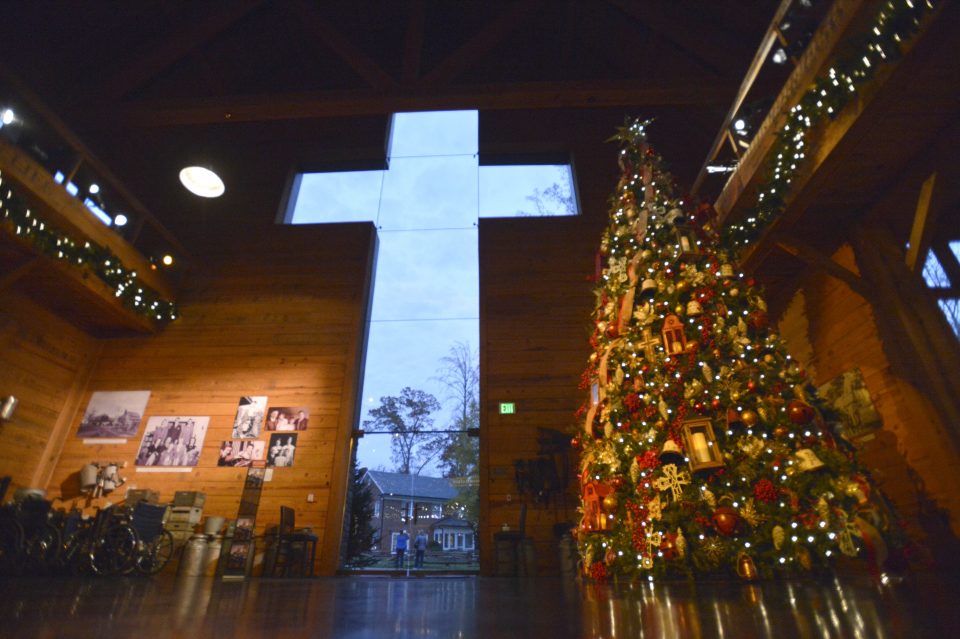 Cross at front entrance of Library and tall Christmas tree