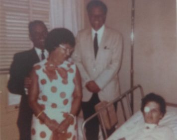 Billy Graham standing beside Wanda Pell's hospital bed