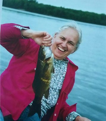 Susan Hoffman in boat holding a bass