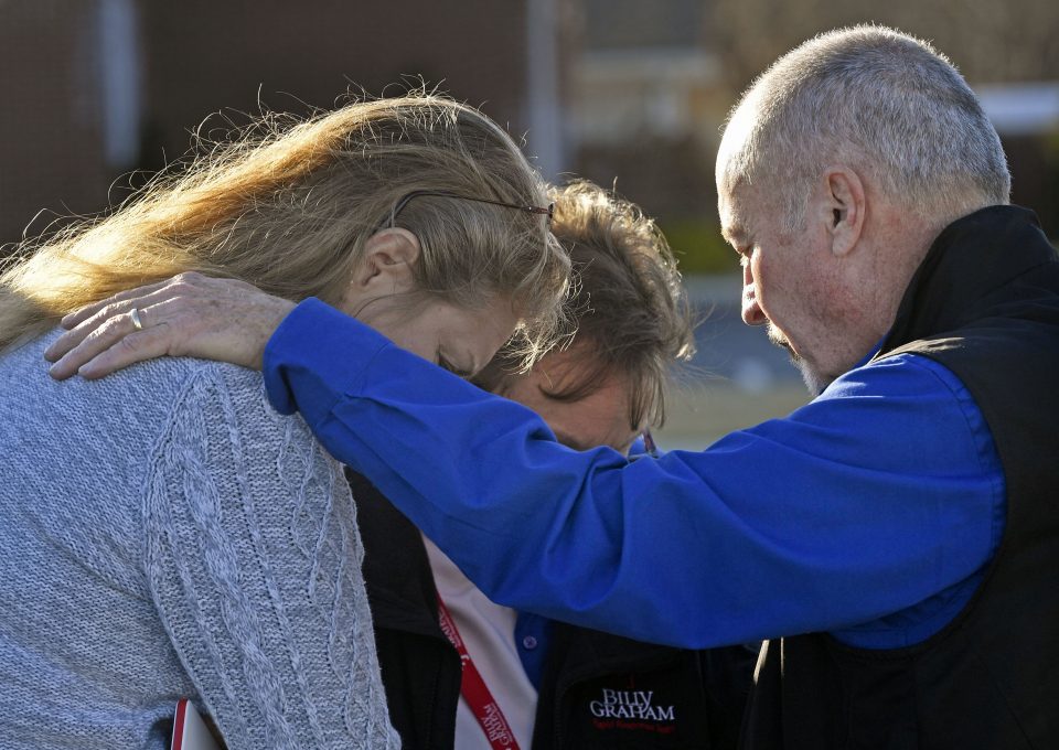 chaplains pray over mother whose son ran out during the school shooting