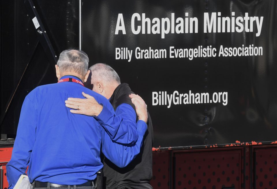 chaplains pray for each other by Mobile Ministry Center