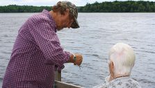 Gary Hand baiting hook for woman in wheelchair