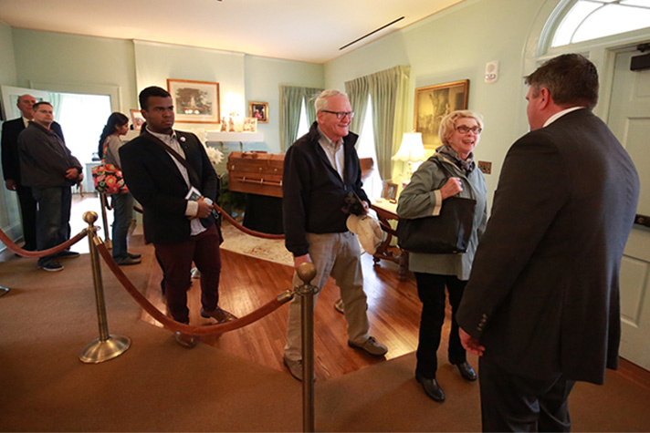 People filing by Mr. Graham's casket; Roy Graham greeting visitors