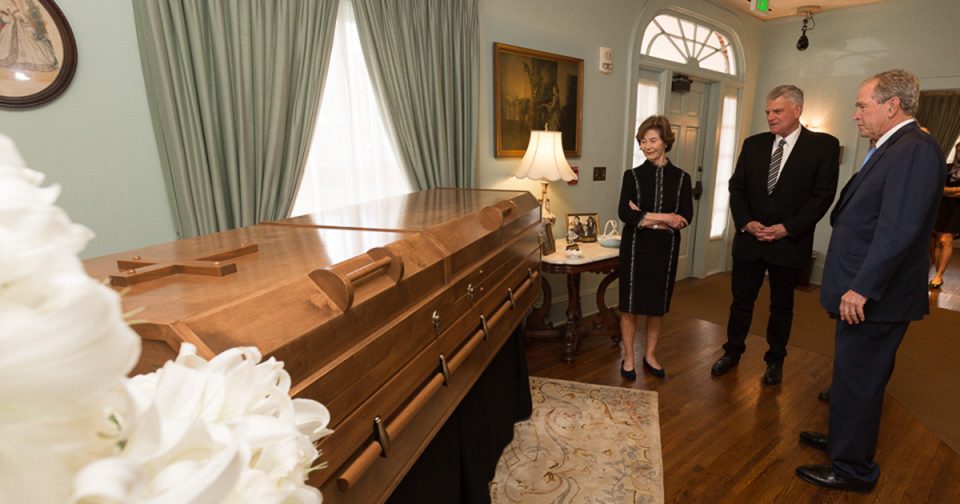 Laura Bush stands by the casket