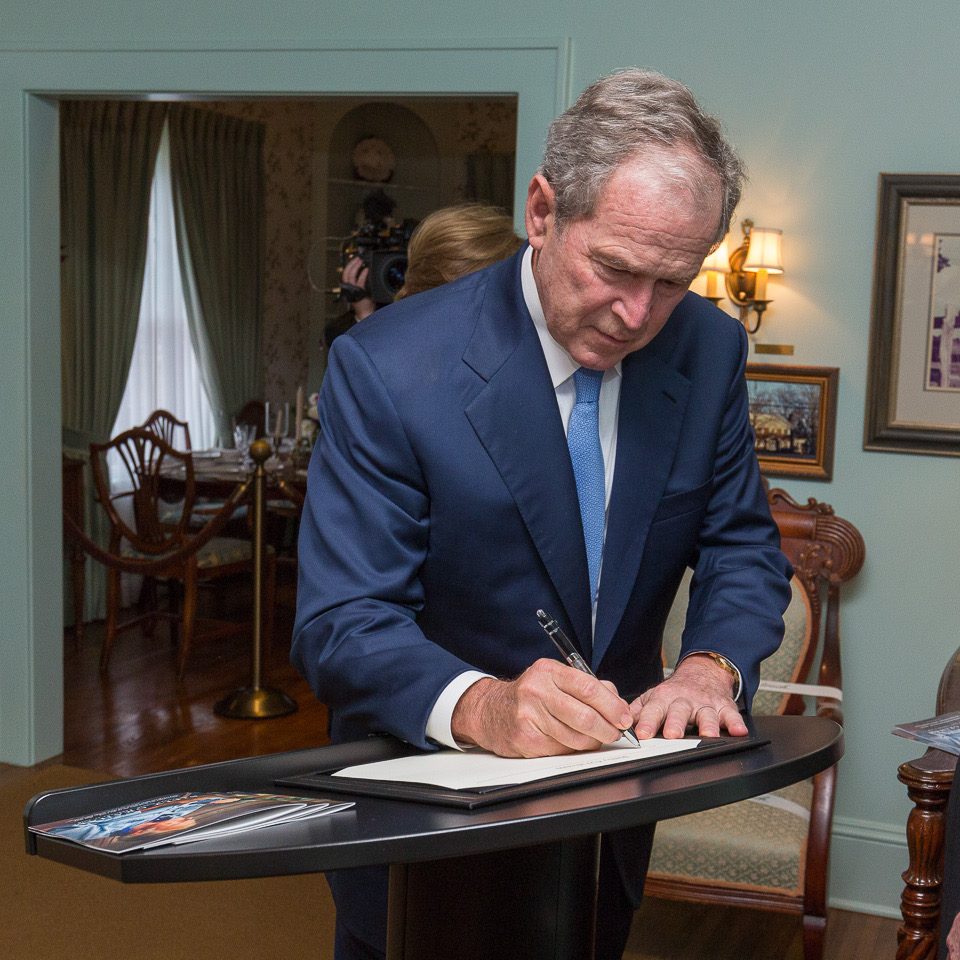 President Bush signs the guest book