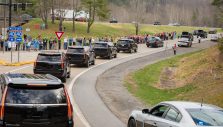 N.C. Residents Line Streets and Highways to Honor Billy Graham as Motorcade Passes By