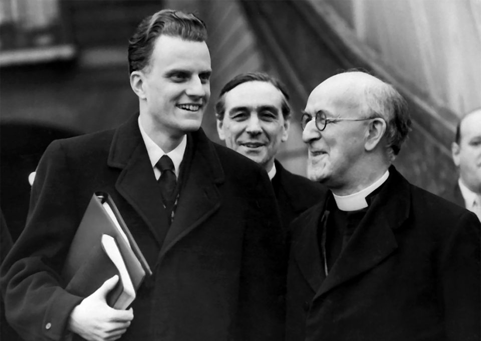 Billy Graham holding Bible and talking with Archbishop of Canterbury Geoffrey Fisher