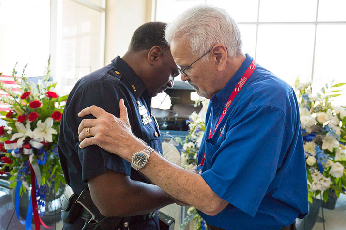 chaplain prays with police officer