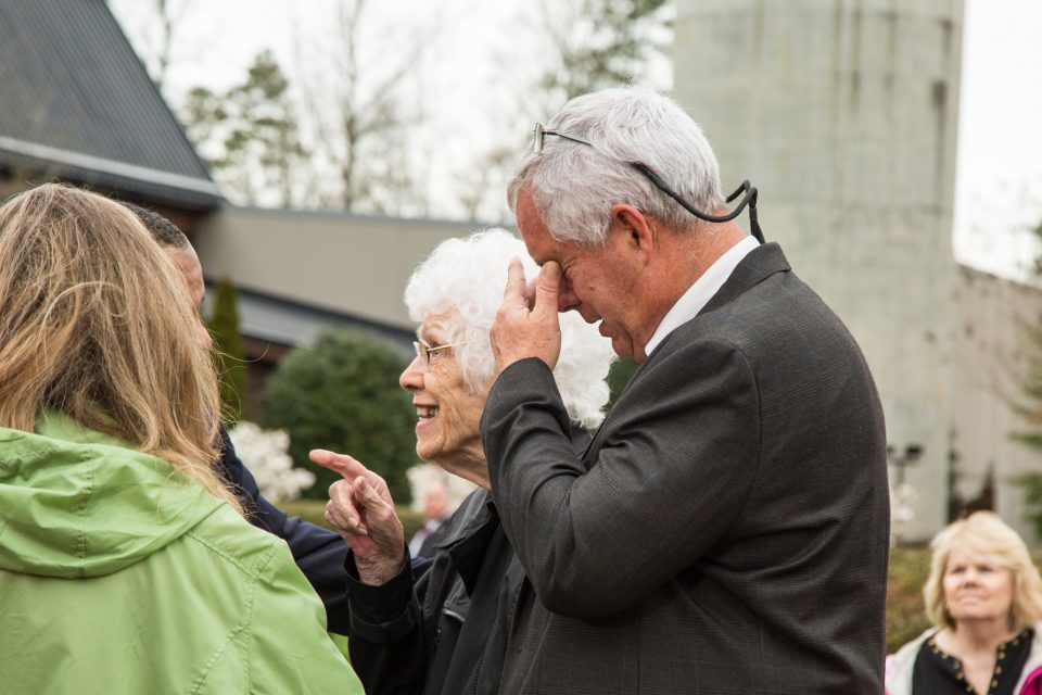 Dave Ballard in tears holding his face, and his mother, Jody 