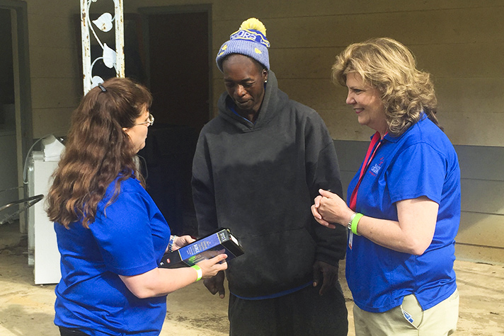 chaplains and homeowner with Bible