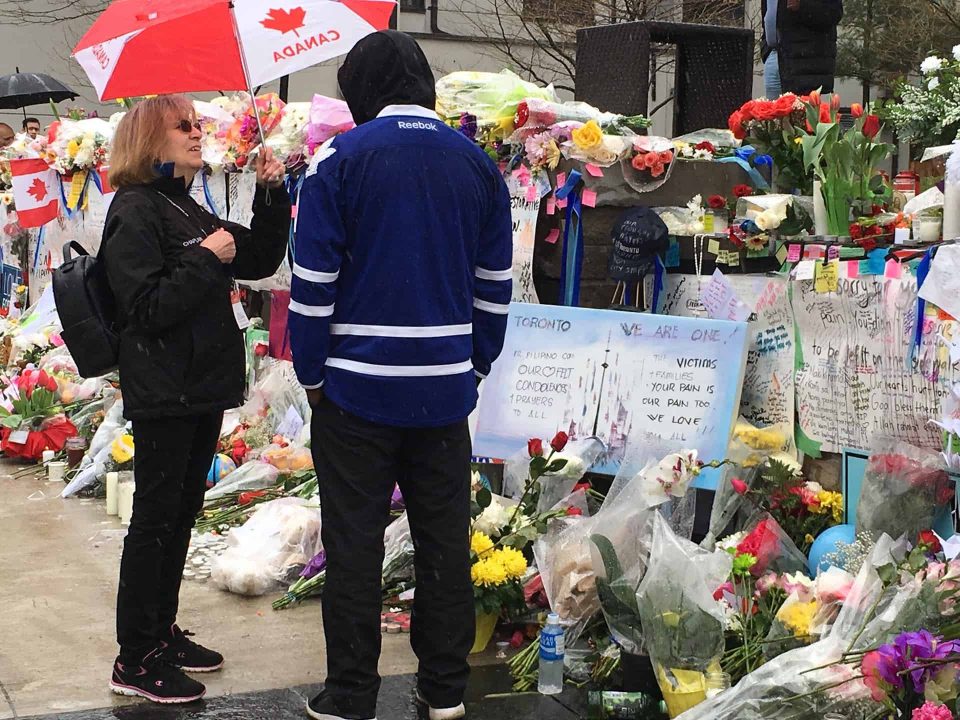 Chaplain talking with person at a memorial site