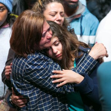 Woman embraces young girl