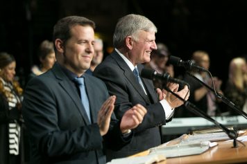 Franklin Graham and an interpreter applauding