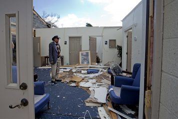 Pastor looking at tornado damage in church