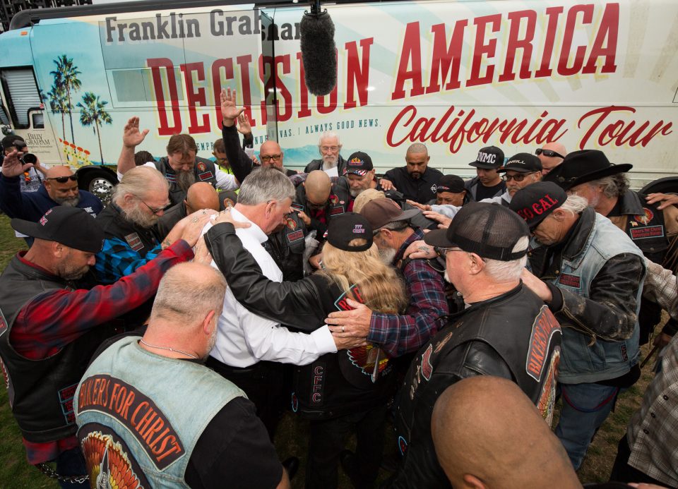 Franklin Graham praying with bikers