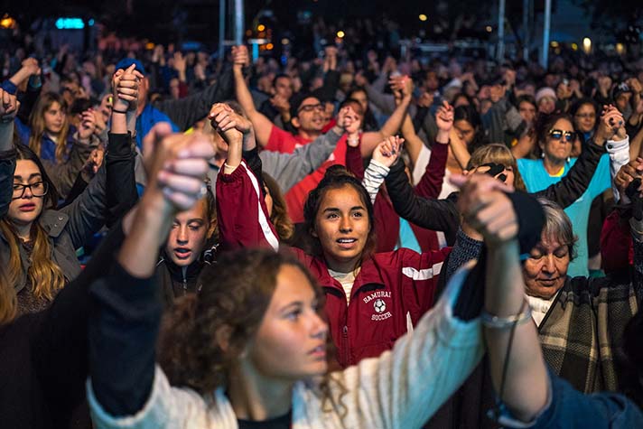 Crowd holding hands raised