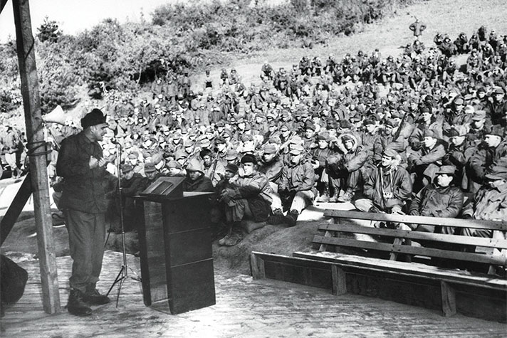 Billy Graham preaching to troops