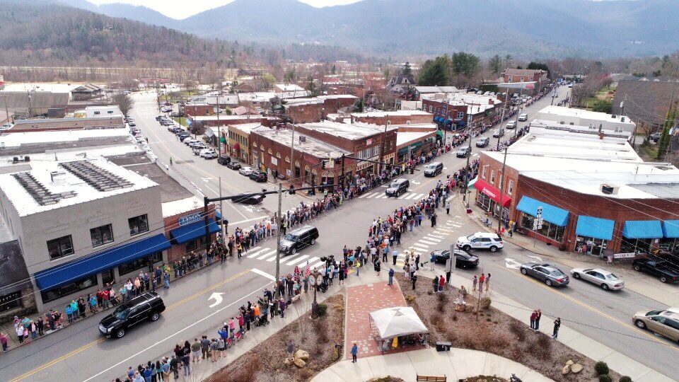 Billy Graham's motorcade passing through Black Mountain, NC. Streets crowded with people