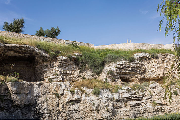 Hill of Golgotha with a wall in the background.