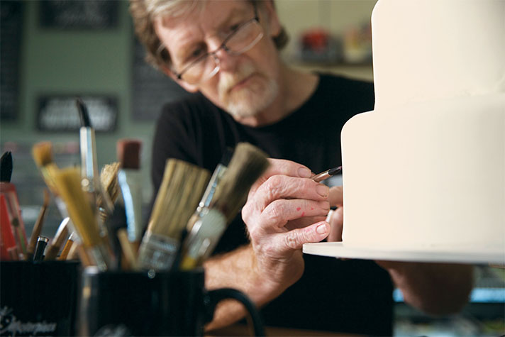 Jack Phillips decorating a cake