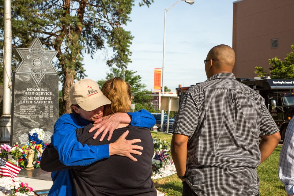 chaplain embraces woman