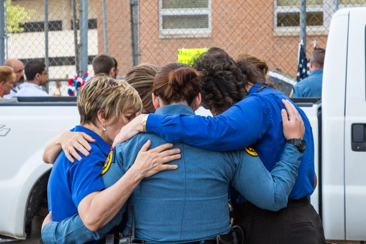 chaplains praying in a circle with officers