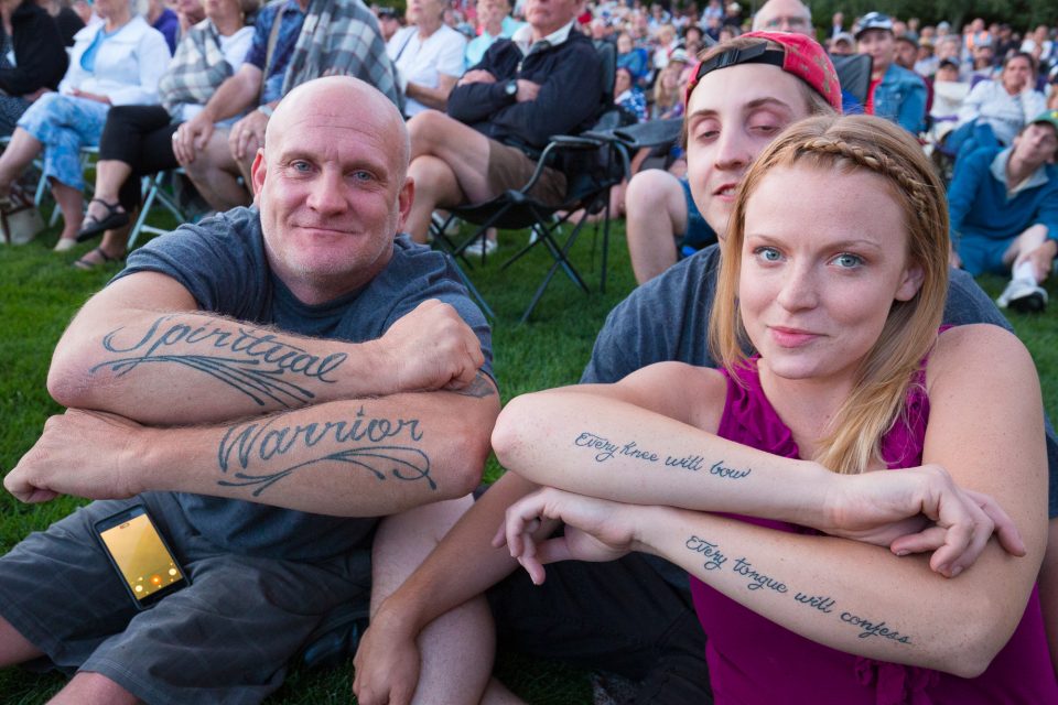 Man and woman showing tattoos