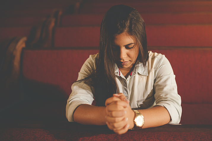 Woman praying in church