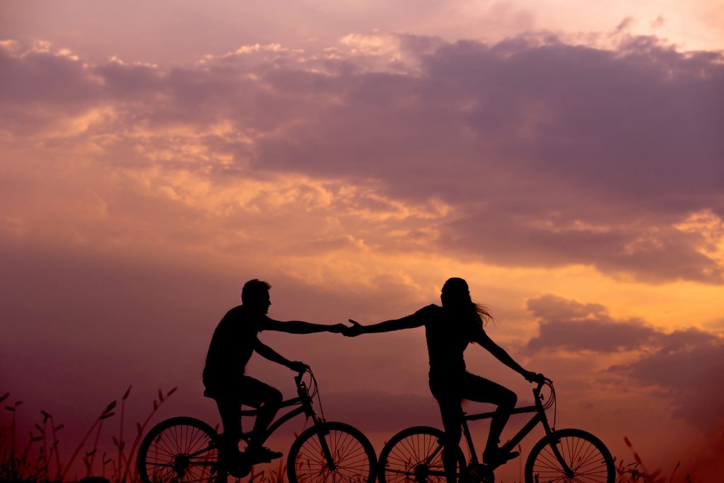 man and woman on separate 
bicycles