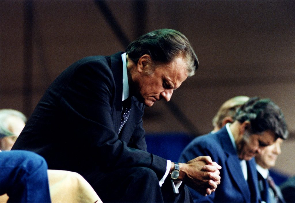 Billy Graham bowed in prayer