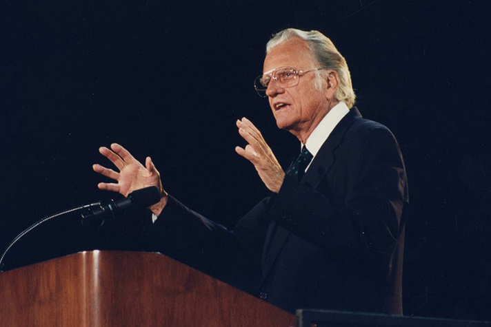 Billy Graham preaching at podium